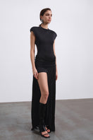 Black SIRA draped open back maxi dress by SÉLONE featuring flowing fabric and elegant draping details.