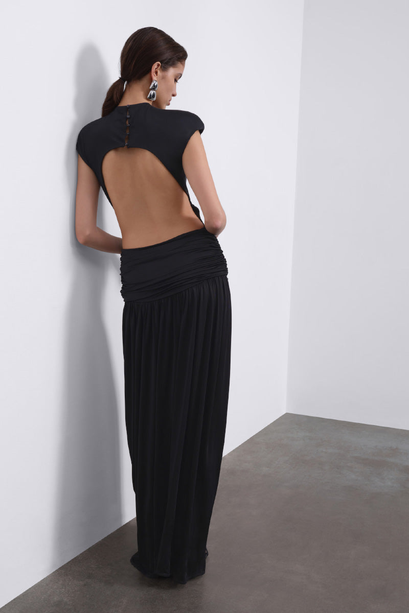 Black SIRA draped open-back maxi dress by SÉLONE, featuring flowing fabric and elegant draping detail.