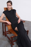 Black SIRA draped open-back maxi dress by SÉLONE, featuring flowing fabric and elegant design, displayed on a hanger.