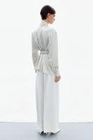 Pearl white wrapped blouse by DELEGAN, stylish shirt with elegant design, shown from the back in this image.