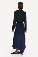 Black tie neck blouse by DELEGAN, showcasing the stylish back view with a sleek, modern design and elegant details.