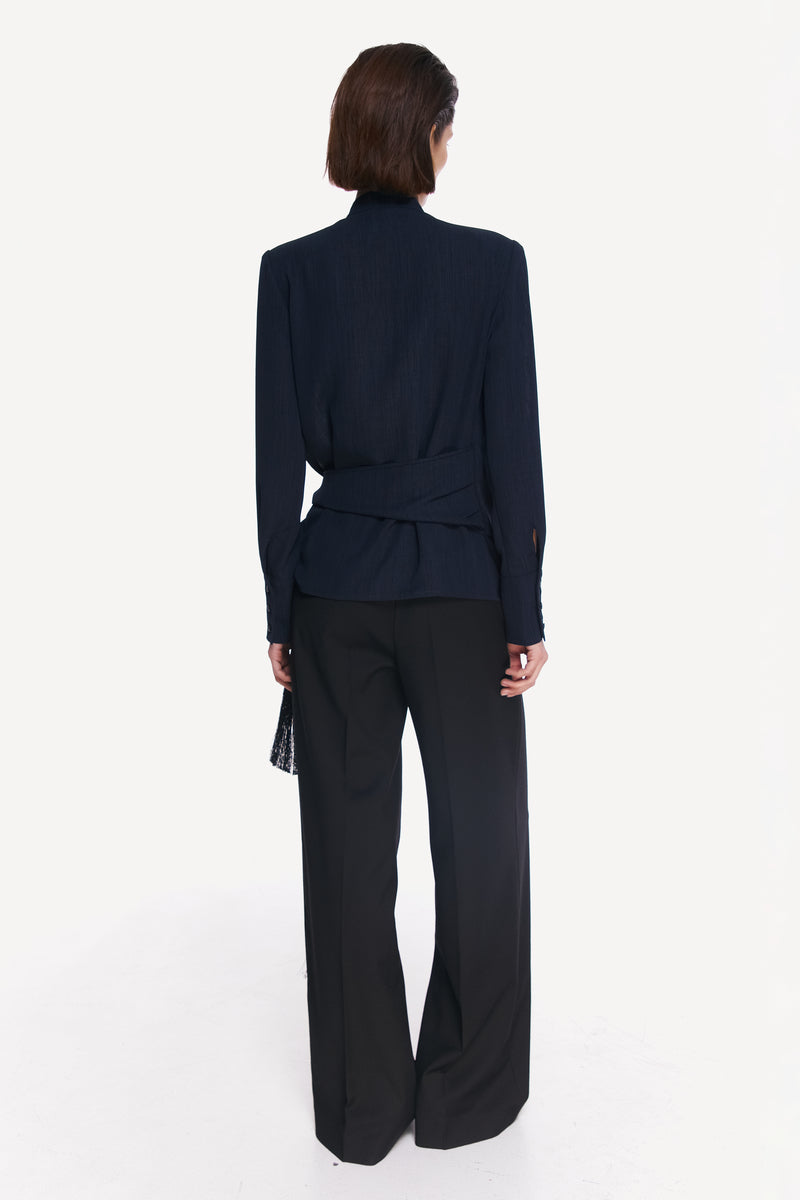 Stylish blue and black belted shirt from DELEGAN, featuring a tailored fit and fashionable design.