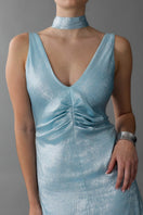 Aisl blue pleated V-neck evening gown with elegant flowing fabric and detailed pleats, perfect for formal events.