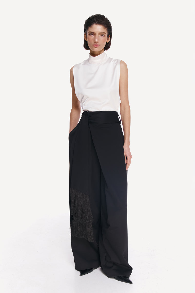 Stylish front view of DELEGAN BAKHROMA pants showcasing their tailored fit and unique fabric details.
