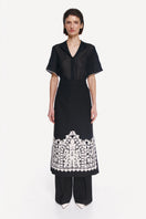 Black DELEGAN shirt with white edging, front view showcasing the stylish collar and clean design.
