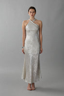 Aisl Celeste Crisscross Ivory Maxi Dress displayed on a model with a front view, showcasing its elegant design and flowing fabric.