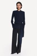 Front view of a stylish blue and black belted shirt by DELEGAN, featuring a modern design with a waist belt detail.