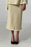 Stylish front view of DELEGAN wool midi skirt with a fitted waist and flowing hem, perfect for fall fashion.