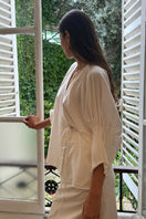 White DELEGAN blouse with tight sleeves, stylish shirt featuring a fitted design and long sleeves, ideal for casual or formal wear.