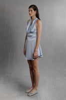 Powder blue satin mini dress by Aisl, draped and stylish, displayed on a mannequin with elegant design details.