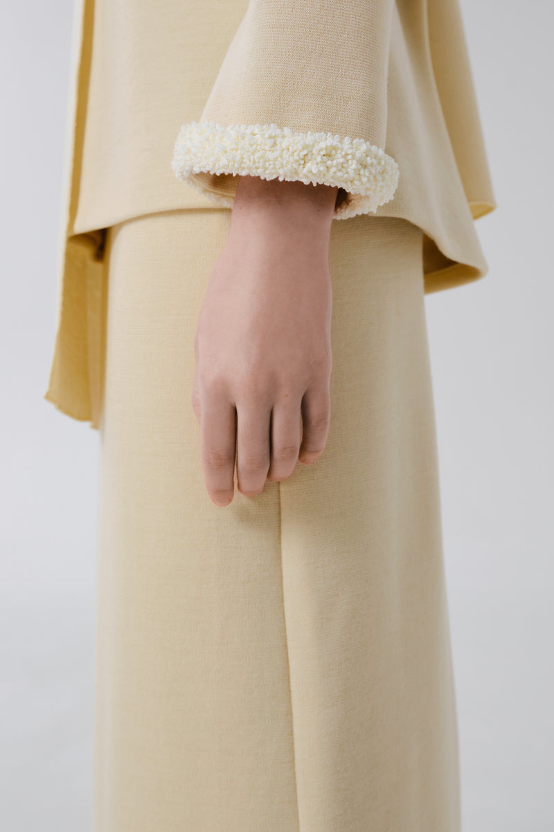 Delegan wool midi skirt displayed from a side view, featuring a classic design and soft fabric for a stylish winter look.