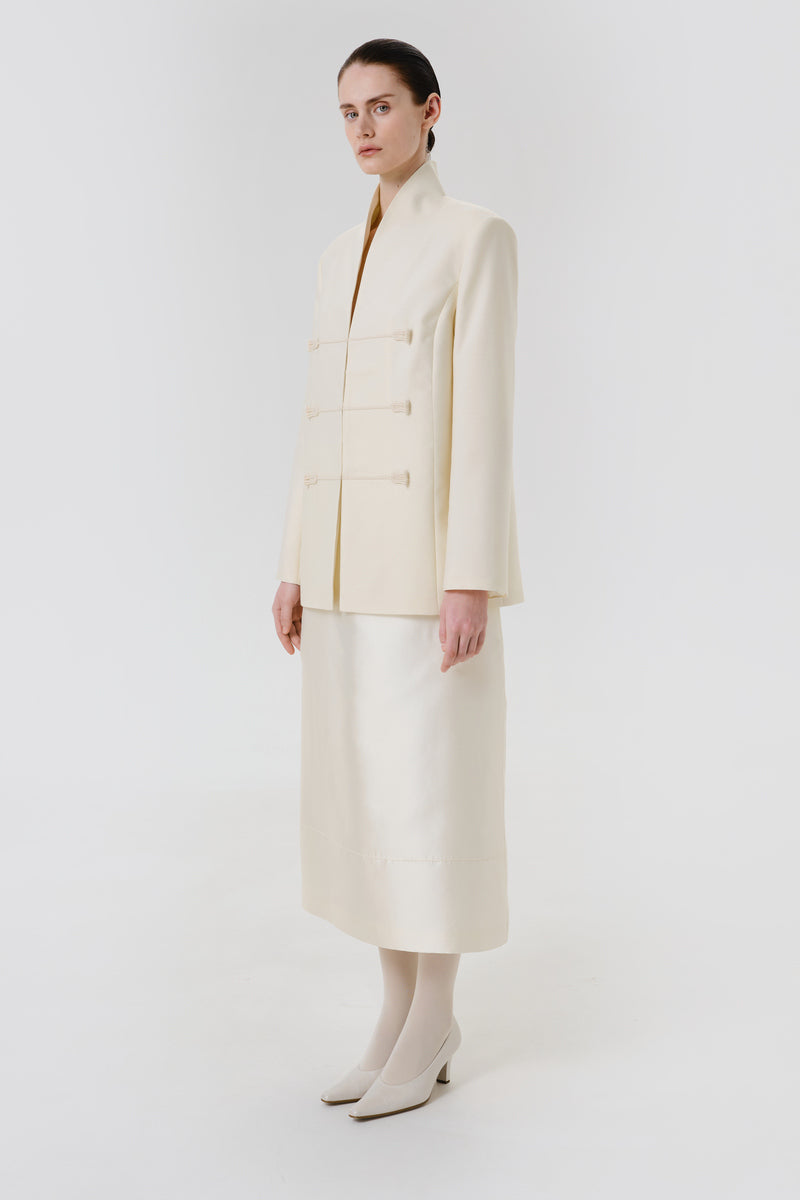 Delegan Still Form blazer jacket shown from side view, tailored fit with structured collar and sleek design.