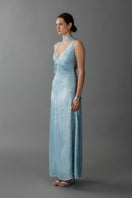 Aisl blue pleated v-neck evening gown displayed from the side with elegant pleats and a flowing silhouette.