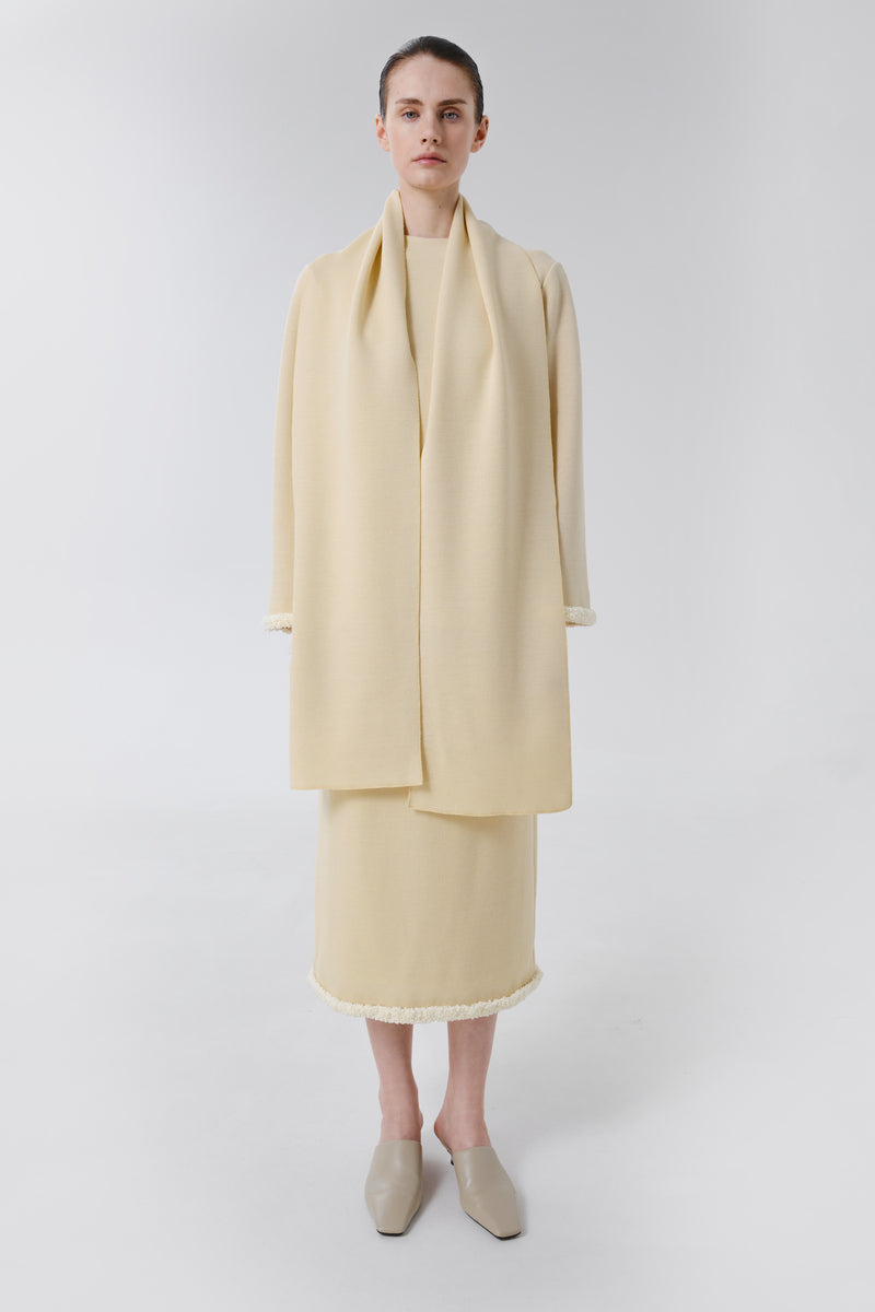 Wool sweater by DELEGAN featuring a cozy, stylish knitted design worn casually with layered clothing.