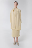 Wool sweater by DELEGAN featuring a cozy, stylish knitted design worn casually with layered clothing.