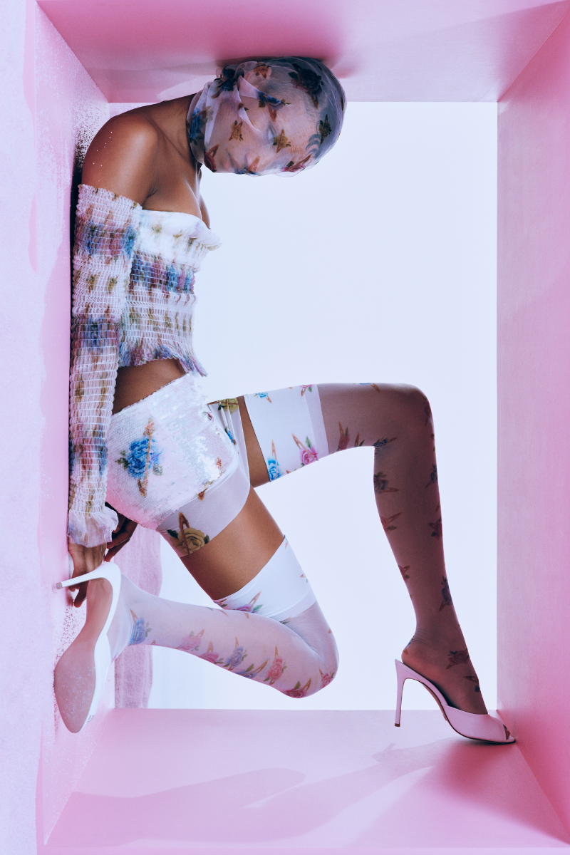 Multicolor floral print low-rise mini skirt by Sudi Etuz, showing the lightweight fabric and stylish design for casual wear.