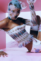 Multicolor floral print low-rise mini skirt by Sudi Etuz with a fitted design and stylish pattern, perfect for casual wear.