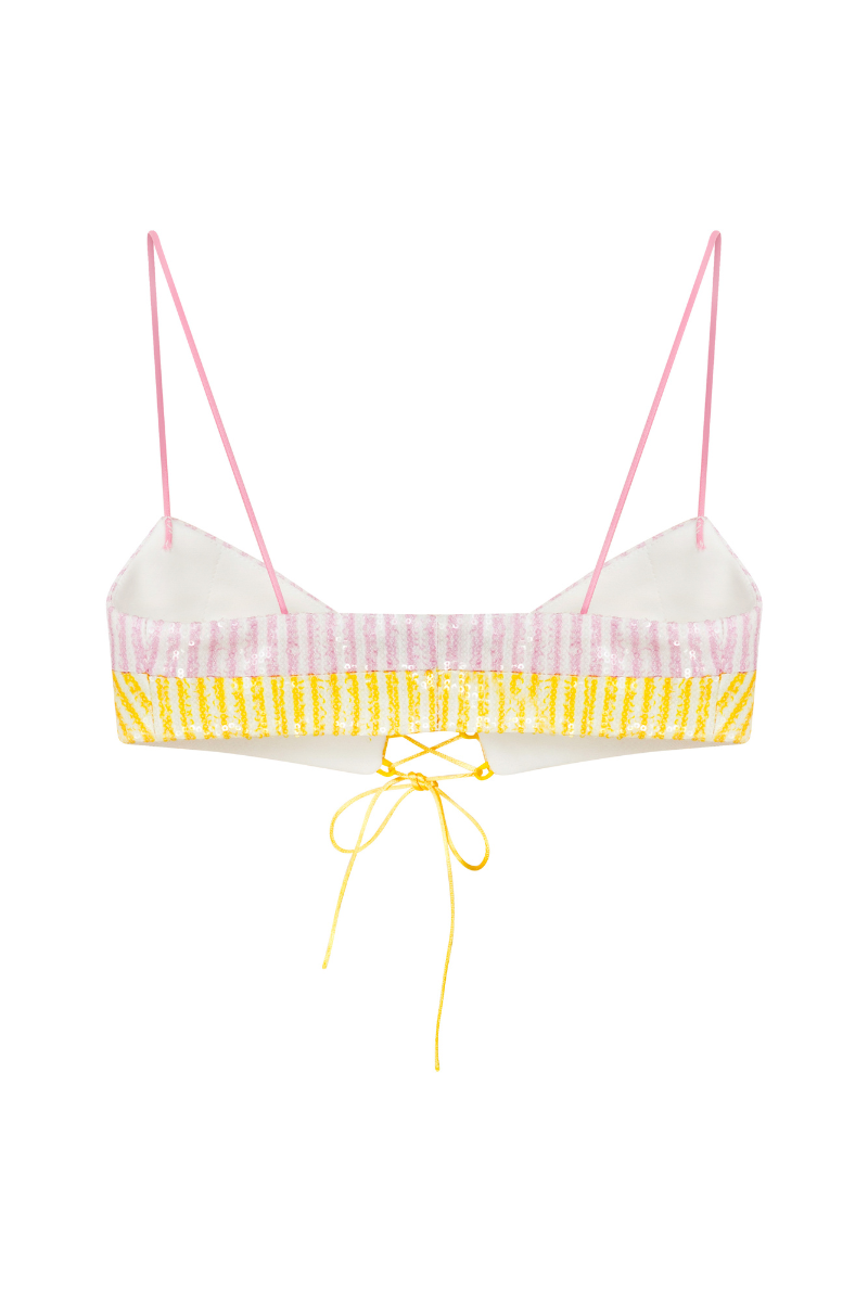 Pink and yellow lace-up front sequin bra by Sudi Etuz, showing a close-up of the sparkling, decorative top with adjustable straps.