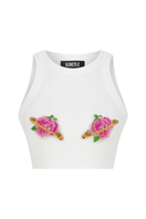 Pink Sudi Etuz cut-out top with handmade flower accessory, featuring stylish design and vibrant color for trendy fashion.