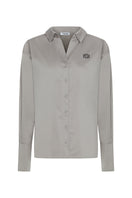 Embroidered oversized shirt by TAGG featuring a logo design and high cuffs, displayed on a mannequin.