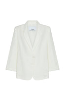 Light beige oversized linen jacket by TAGG, shown on a hanger, with a relaxed fit and natural texture.