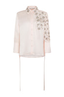 Embroided oversized shirt by TAGG, featuring detailed embroidery and relaxed fit, shown in a casual, stylish wear.