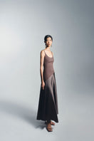 Brown slit curve maxi dress by TONYY, featuring a flowing design and elegant silhouette, shown in a close-up view.