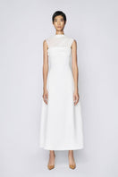 White pleating shoulder maxi dress by TONYY, featuring flowing fabric and elegant design, displayed on a white background.