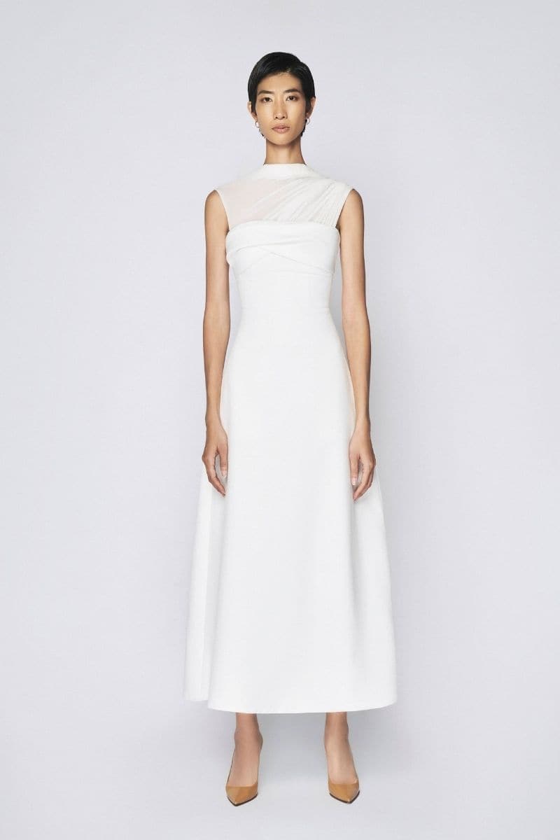 White pleating shoulder maxi dress by TONYY, featuring flowing fabric and elegant design, displayed on a white background.