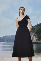 Black asymmetric crystal-embellished one-shoulder midi dress by Tracy Studio, featuring elegant embroidery and a fitted silhouette.