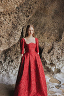 Red long sleeve gown with curved neckline by Tracy Studio, full-length dress perfect for elegant occasions.