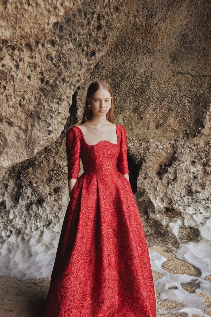 Red long sleeve gown with curved neckline by Tracy Studio, full-length dress perfect for elegant occasions.