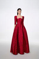 Red long sleeve gown with curved neckline by Tracy Studio, full-length dress for elegant occasions.