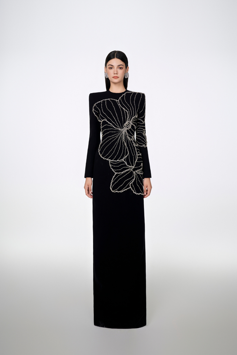 Black long sleeve orchid patterned body-con gown by Tracy Studio, close-up of fitted dress with floral design.