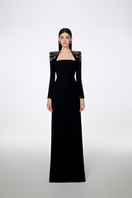 Black Tracy Studio long sleeve trapezoid neckline bodycon gown, fitted full-length dress with elegant design.