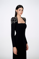 Black Tracy Studio long sleeve trapezoid neckline bodycon gown, full-length dress with fitted silhouette and elegant design.
