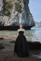 Black strapless gown with stone embellishments by Tracy Studio, full-length dress perfect for formal occasions.