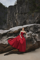 Red strapless pleated full gown by Tracy Studio, showcasing elegant design and flowing fabric in a full-length dress image.
