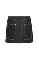 Denielle William St denim mini skirt by TT Studios, shown on a model, featuring classic blue denim and a fitted style.