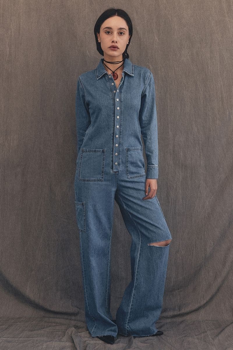 TT Studios Deanna Union Square denim jumpsuit, fitted style with square neckline, shown in XS size on a model.