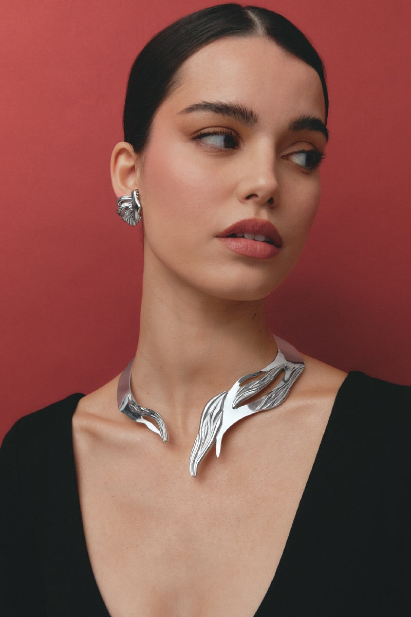 Silver UNA earrings by Jude Benhalim, featuring sleek, minimalist design with a polished finish, displayed on a model.