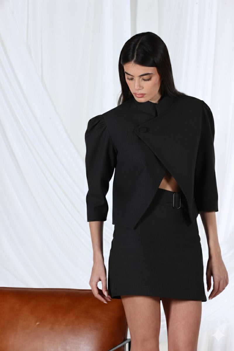 Black Iris mini skirt by Aquarel Studio, shown on a model, featuring a fitted high-waist design and sleek fabric.