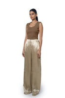 URA Marie trousers in champagne, stylish pants with a tailored fit, shown in a light champagne color on white background.