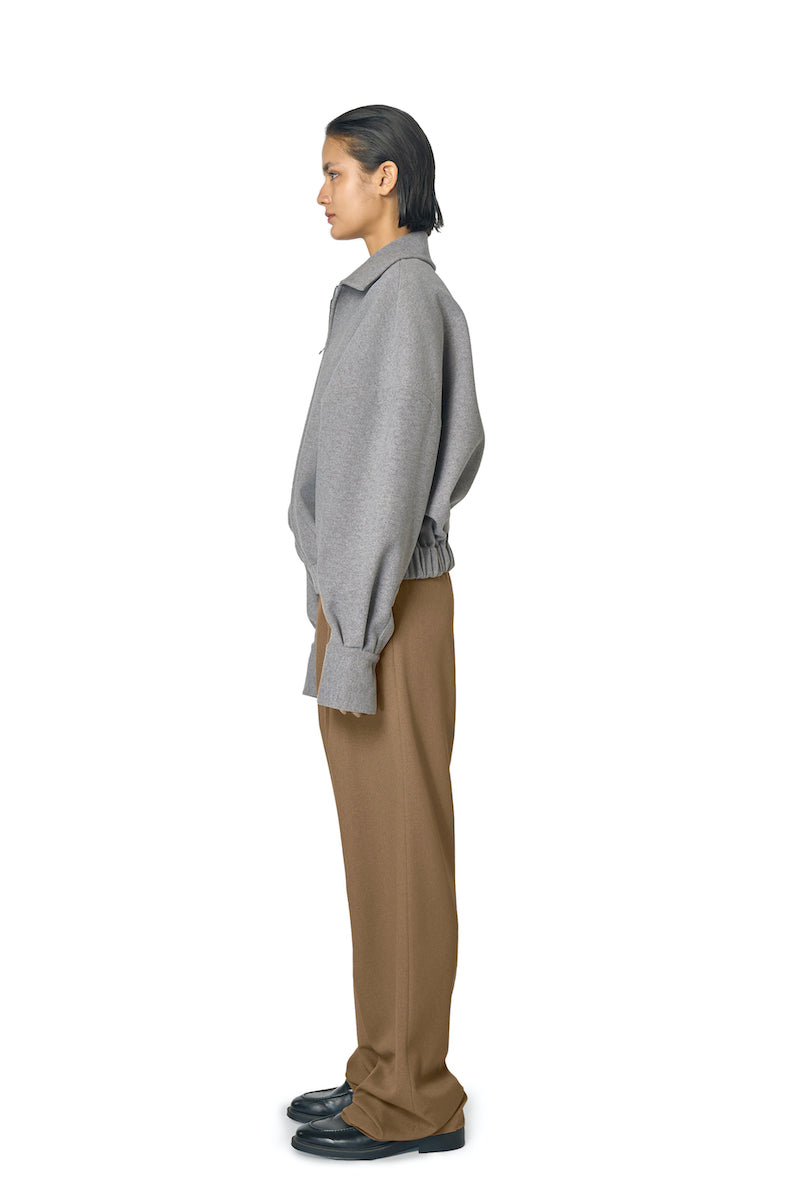 Gray STEPH jacket by URA, featuring a stylish design with a zip-up front and comfortable fit, shown on a model.