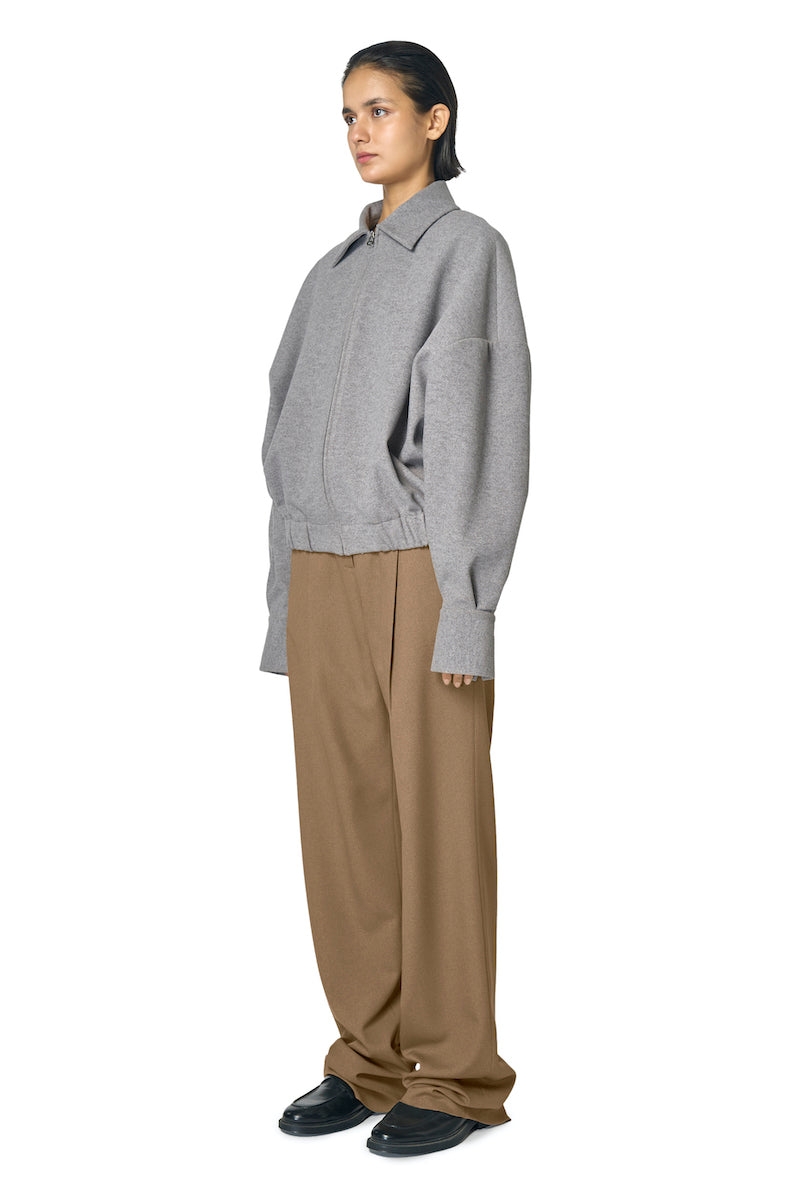 Gray URA Steph jacket displayed on a hanger, featuring a stylish, modern design with a zip front and comfortable fit.