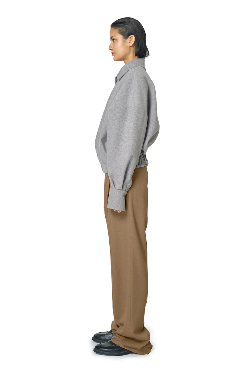 Gray Steph jacket by URA featuring a stylish, fitted design with a smooth fabric finish, displayed on a hanger.