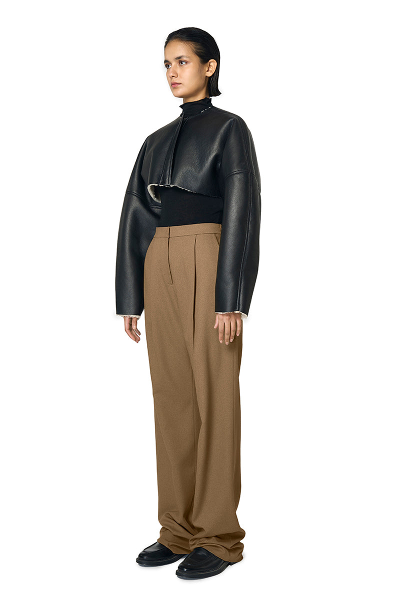 Black Adele bomber jacket by URA featuring a stylish, fitted design and ribbed cuffs on a mannequin.