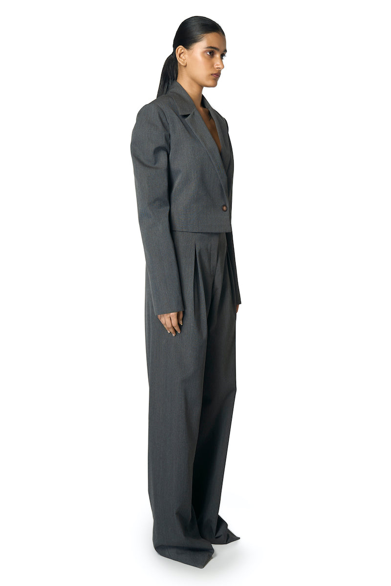 Gray Rudy jacket by URA, featuring a modern design with a tailored fit, displayed on a hanger.