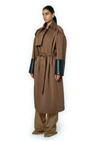 URA ADA camel coat displayed on a hanger, showcasing its stylish design and neutral camel color.