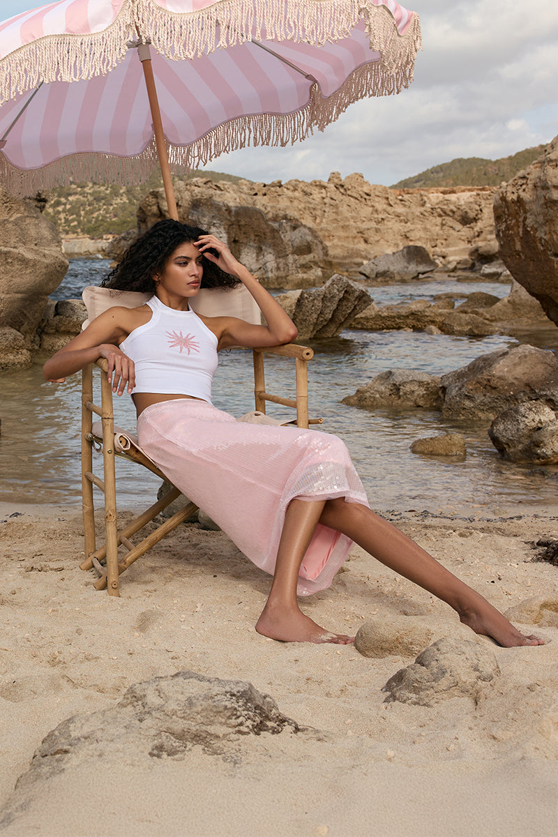 Ikinita Sunrise Top, a stylish blouse with vibrant colors and flowy fabric, perfect for casual or dressy occasions.